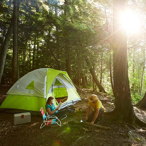 A couple sitting around their campsite