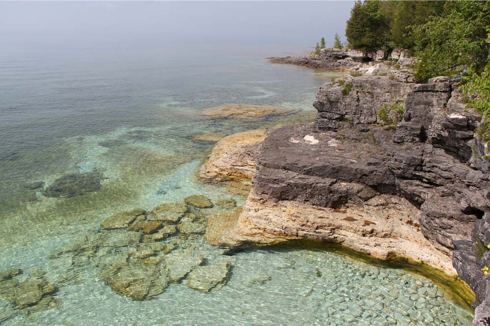 Aerial view of shallow water along the cliff line.